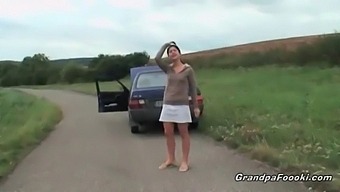 A Charming Young Woman Entices An Elderly Man During A Car Trip